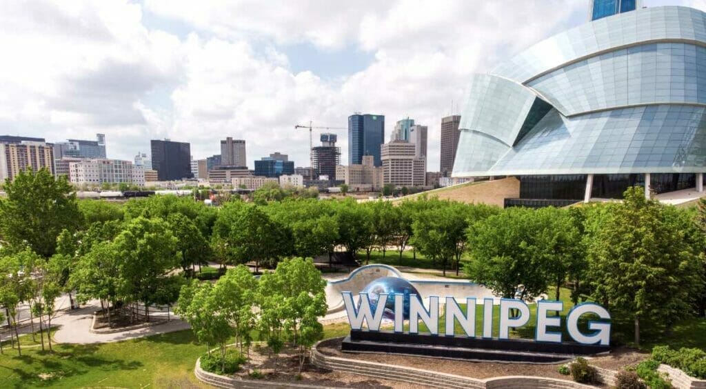 An image of the Winnipeg signage in front of the Canadian Museum for Human Rights at the Forks.