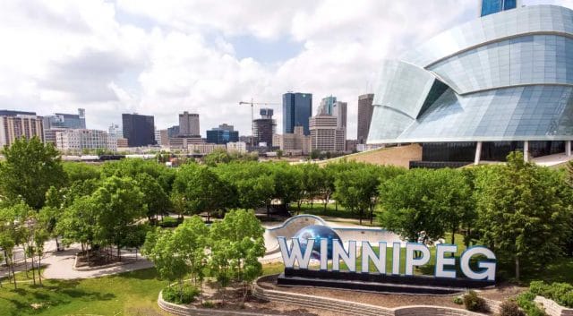 An image of the Winnipeg signage in front of the Canadian Museum for Human Rights at the Forks.