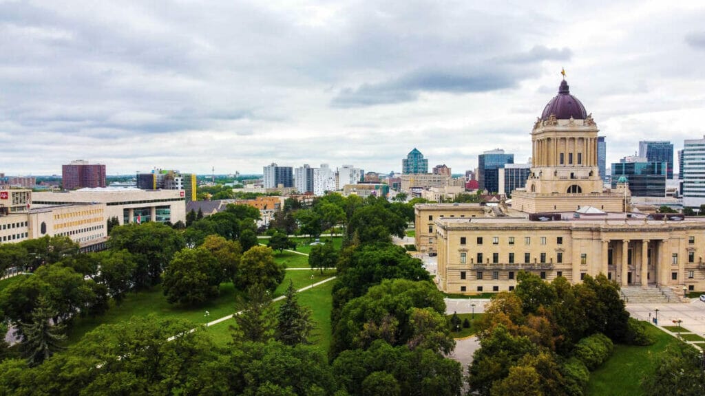 An image of the park next to the Manitoba Legislative Building, with the Golden Boy on the very tip of the building.