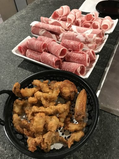 The appetisers are Deep-Fried Pork With Pepper Corn and the Fried Chicken Wings, with the sliced meats in the background